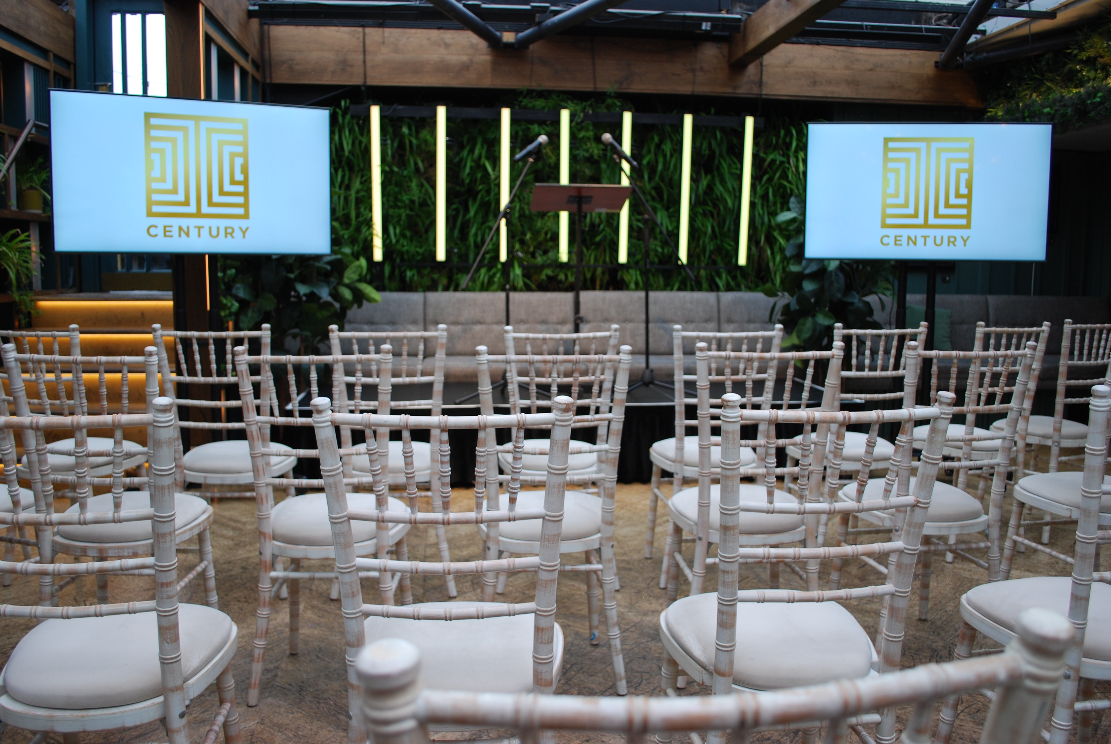 Roof terrace conference space with retractable glass roof, ideal for presentations and events.