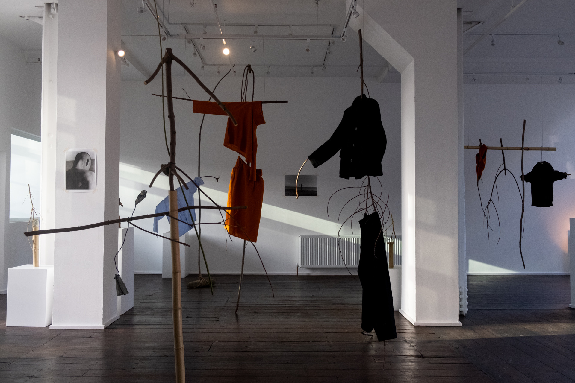 Art installation with unique textiles in spacious gallery for creative workshops.