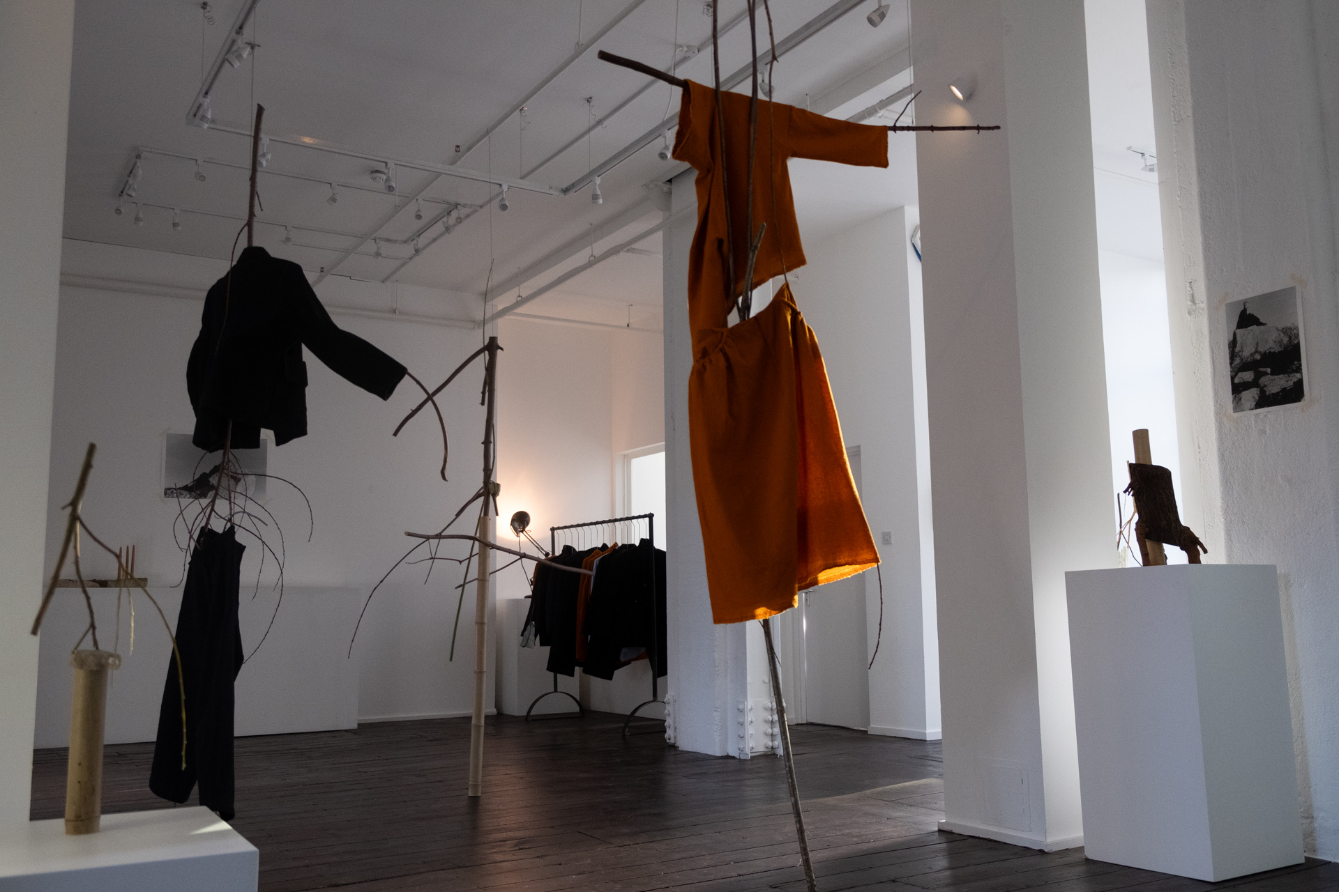 Minimalist installation with suspended garments for fashion events and art exhibitions.