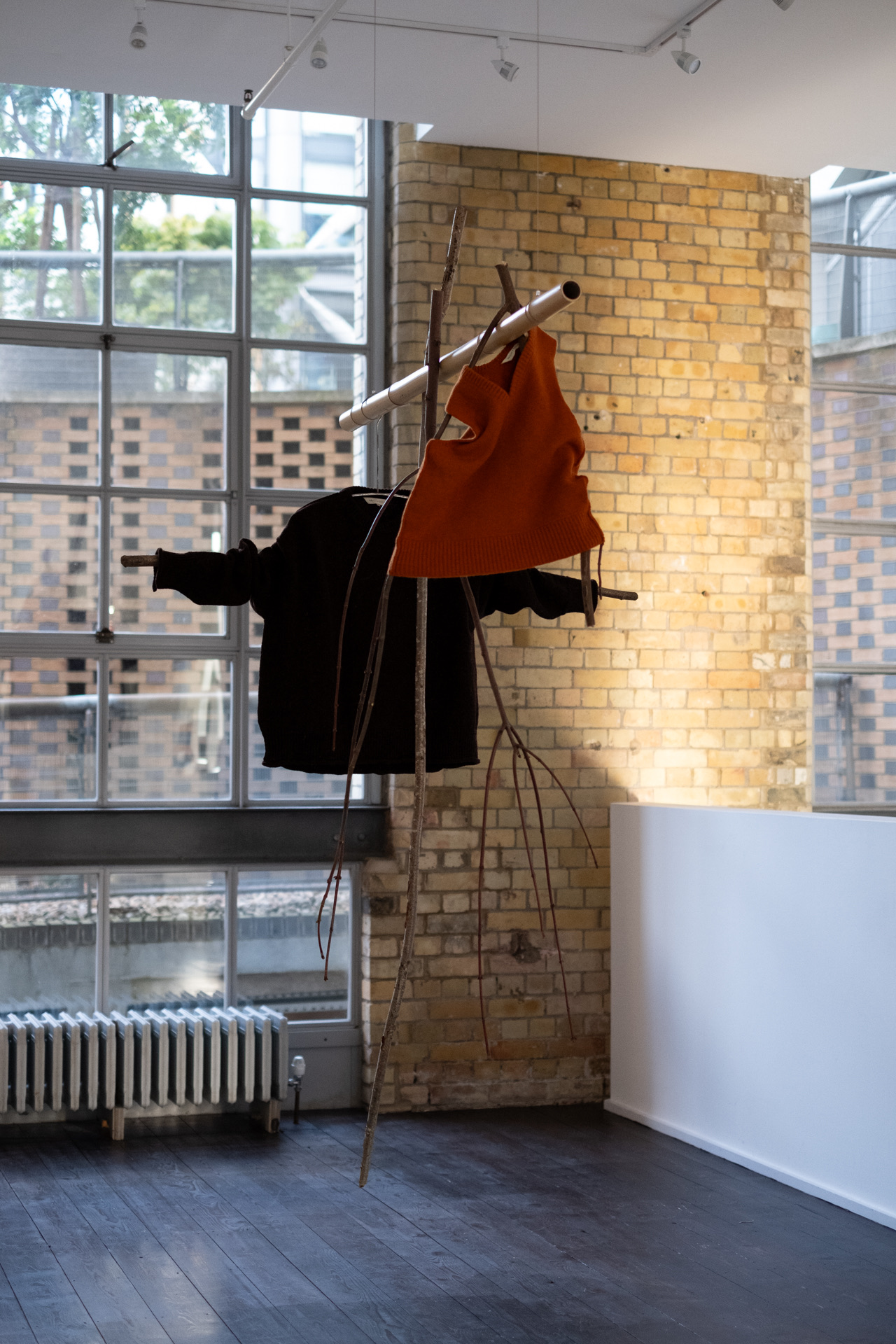 Minimalist clothing display at Ensō London, emphasizing innovative event design and atmosphere.