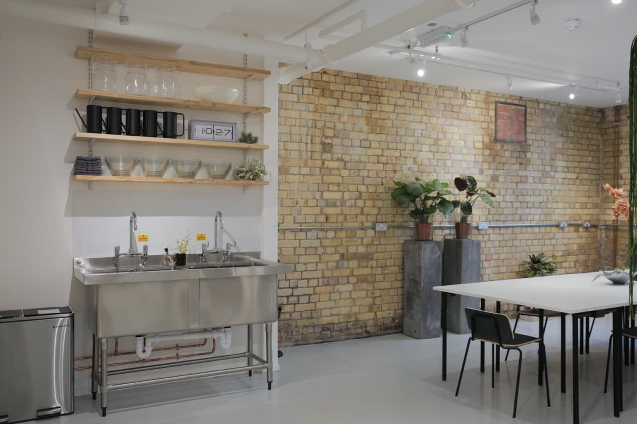 Modern refreshment area with stainless steel sink, ideal for networking events.