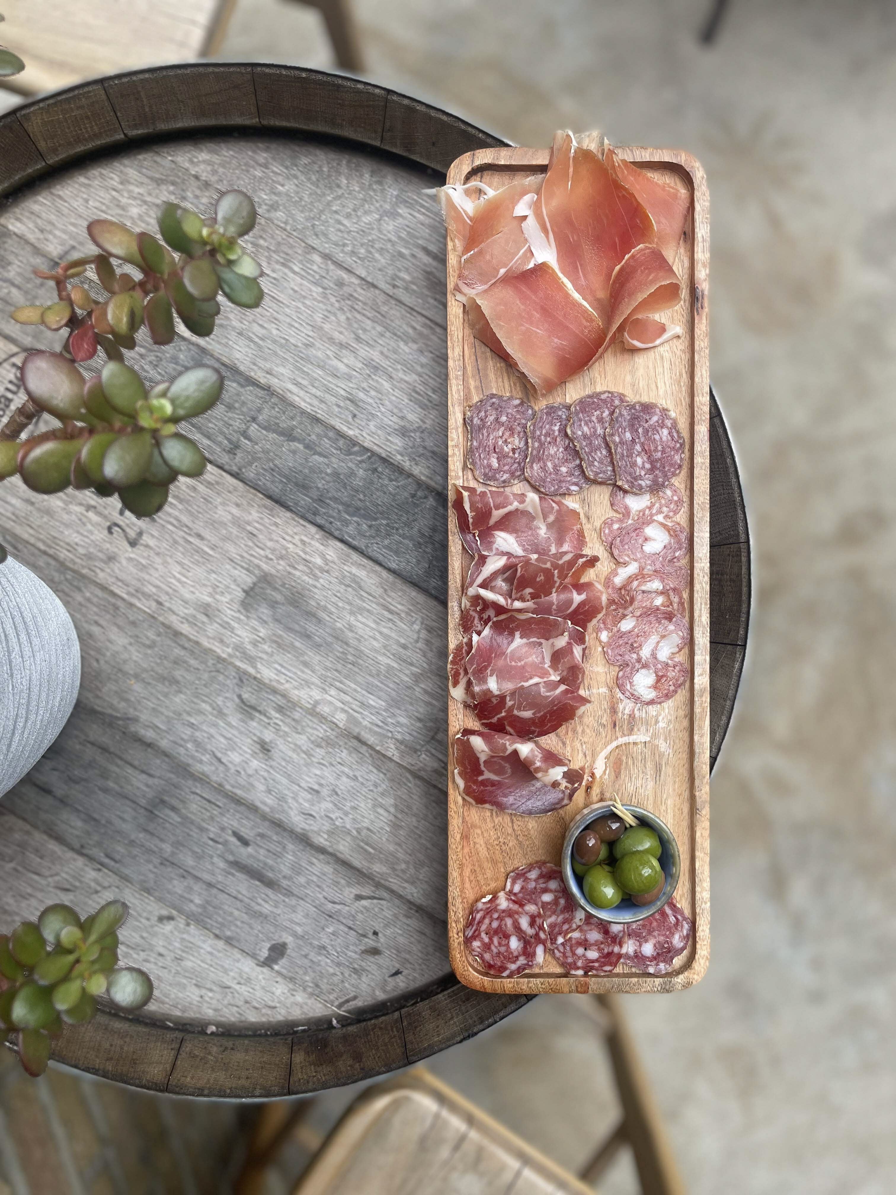 Elegant charcuterie board with cured meats and olives for networking events.