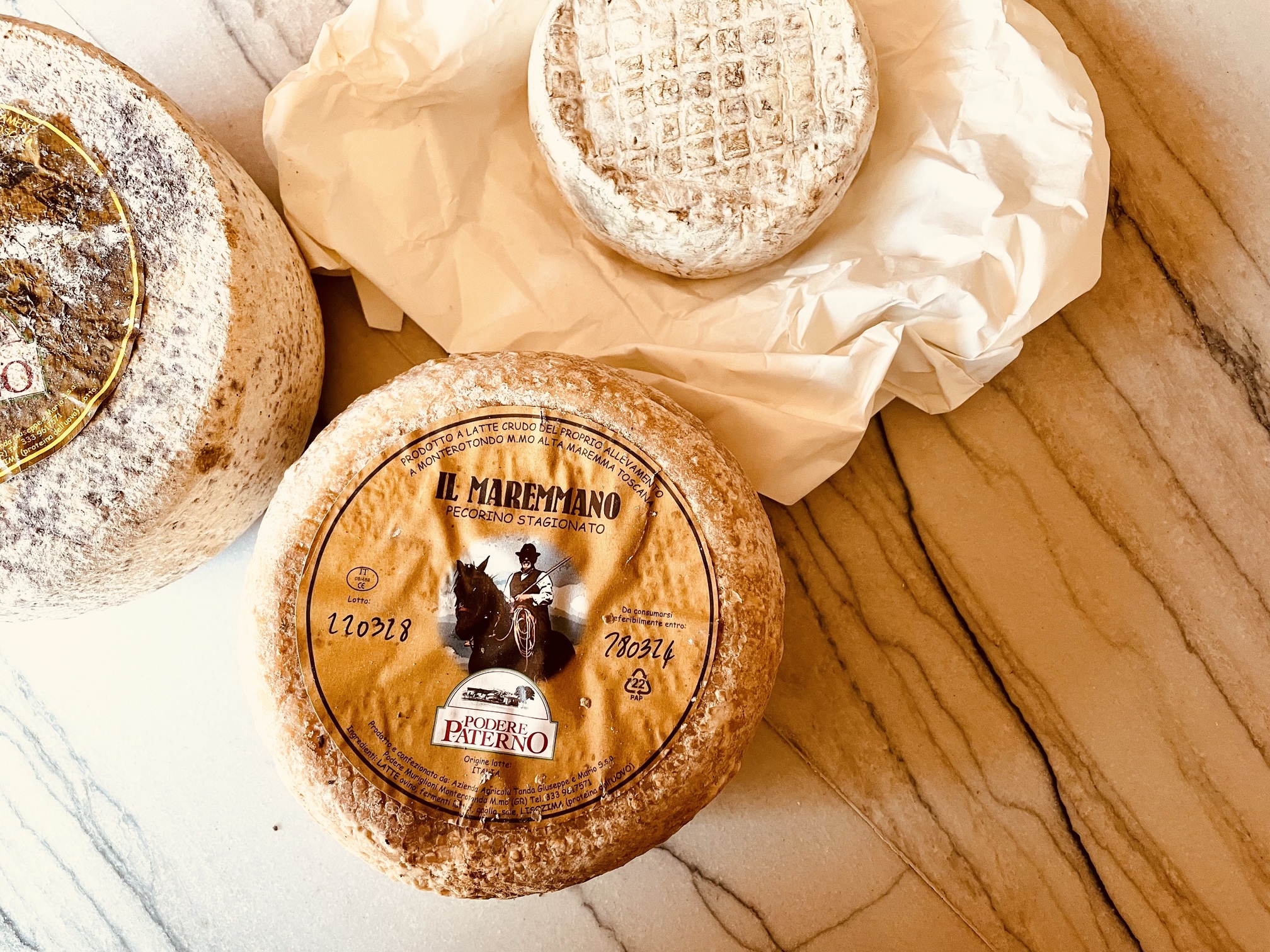 Artisanal cheeses in elegant packaging for gourmet catering at upscale events.