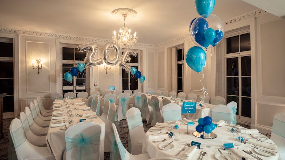 Elegant event space at Dyrham Park with blue accents for milestone celebrations.