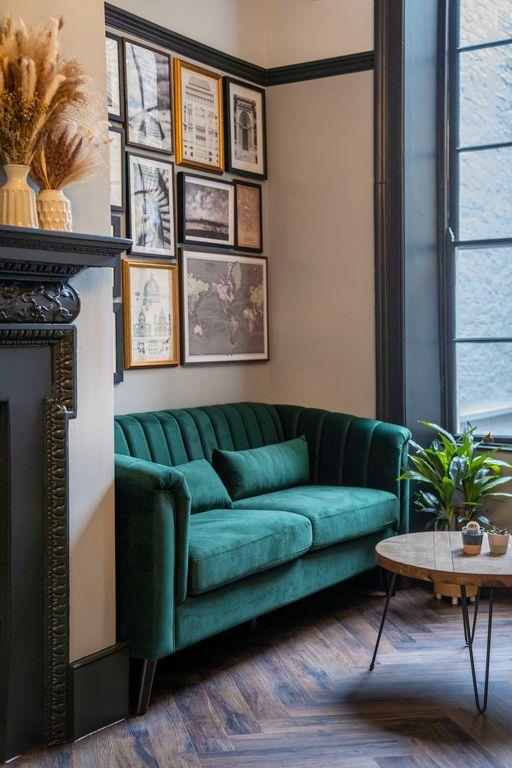 Stylish Members Lounge with plush green sofa, ideal for networking events and meetings.