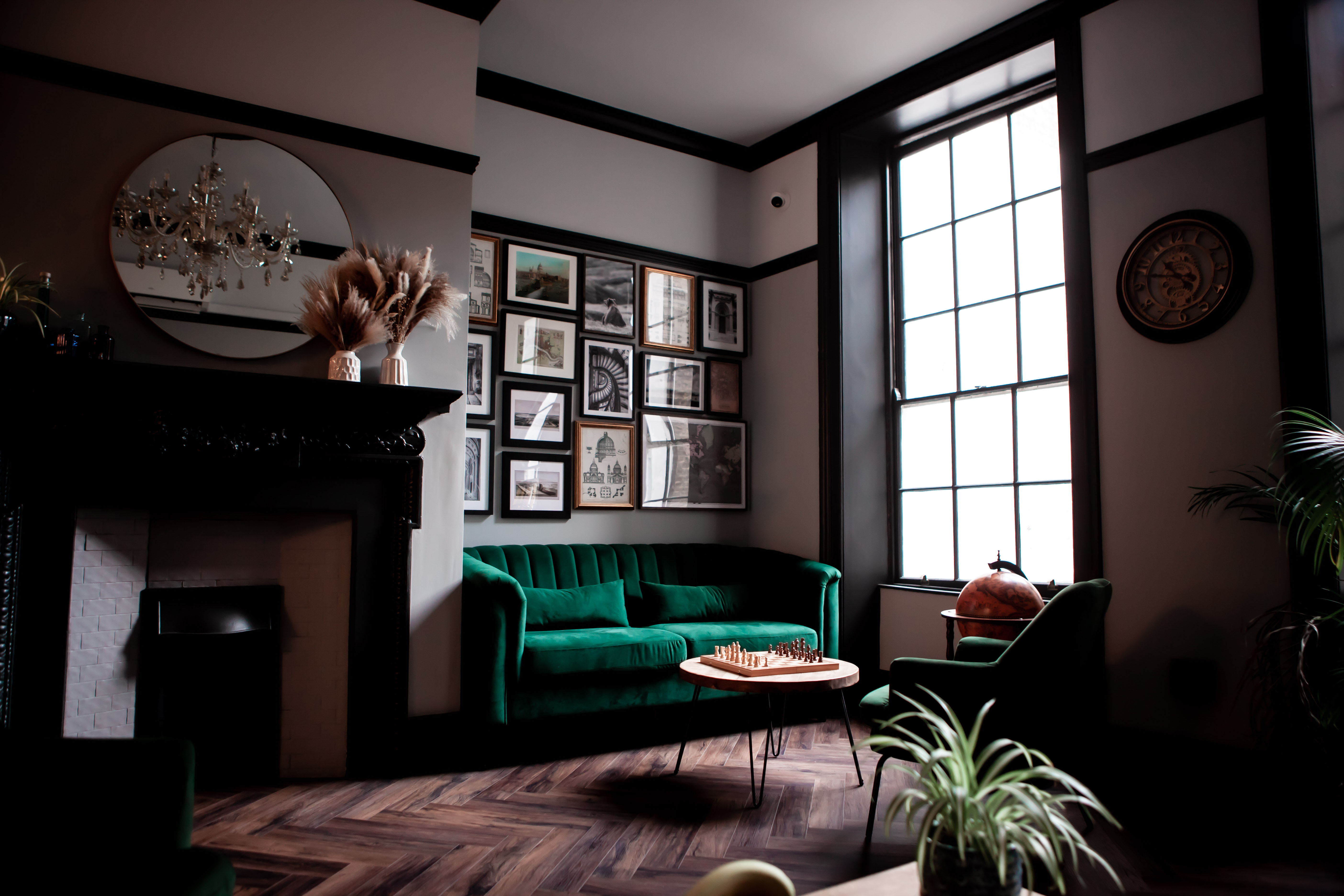 Stylish Members Lounge with green velvet seating, ideal for meetings and networking events.