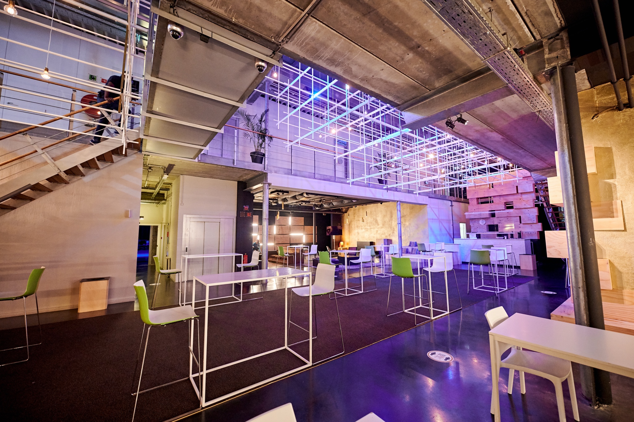 Modern event space with high-top tables, perfect for networking and receptions.