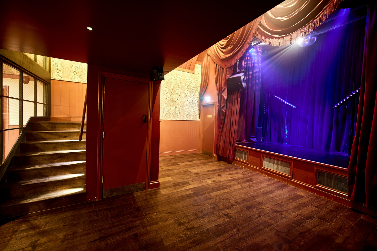 Elegant event space at Rae's in Omeara, featuring intimate stage and warm lighting.