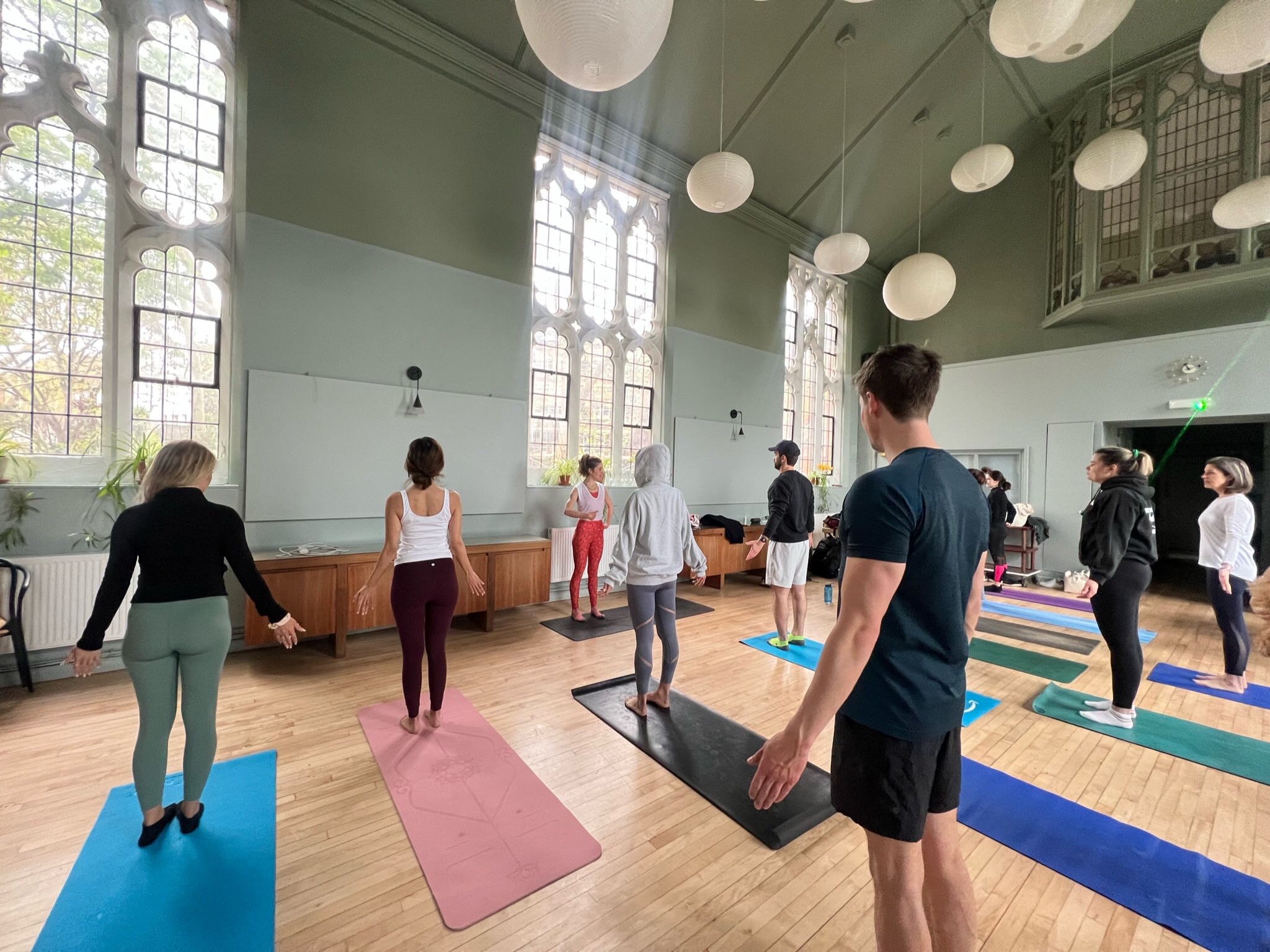 Yoga session in a spacious, well-lit venue for wellness retreats and corporate programs.