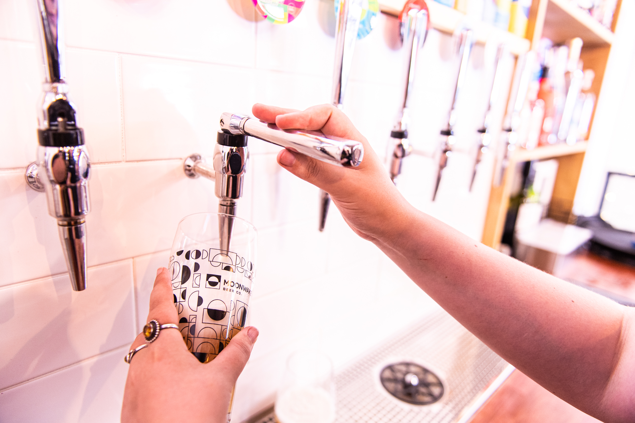 Hand pouring a drink at The Back Bar in Moonwake Taproom for events and gatherings.