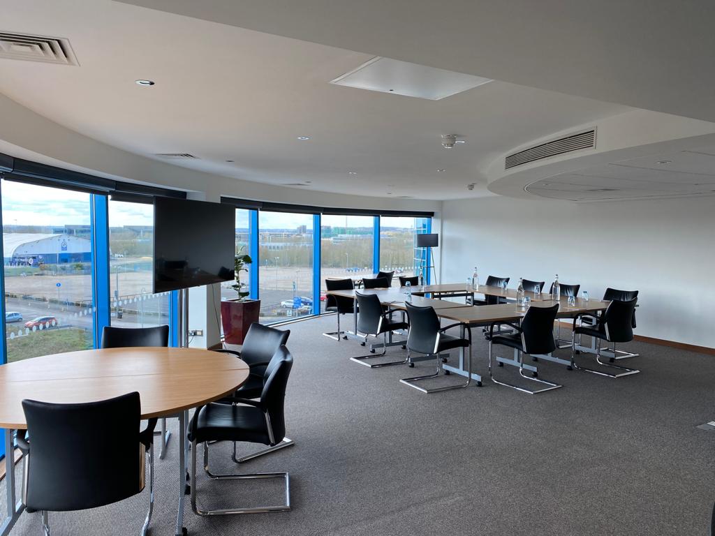 Modern meeting space in Srivikorn Suite, Voco Reading, with natural light and collaboration setup.