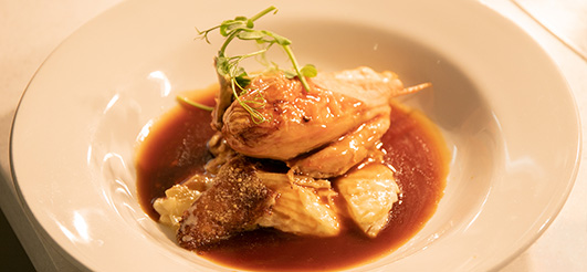 Plated chicken dish with microgreens, showcasing quality catering for events.