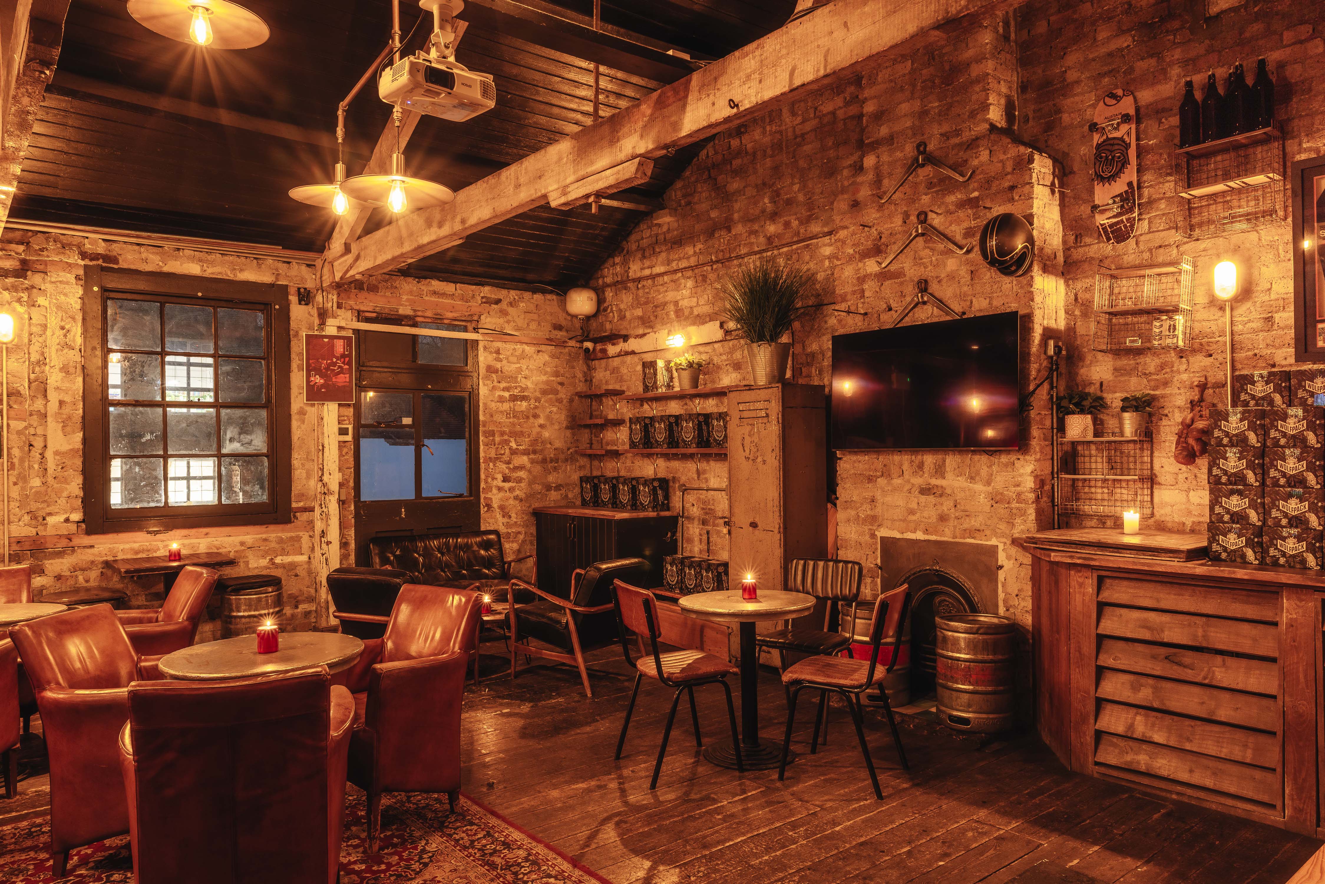 Cozy rustic event space with exposed brick for intimate gatherings and meetings.