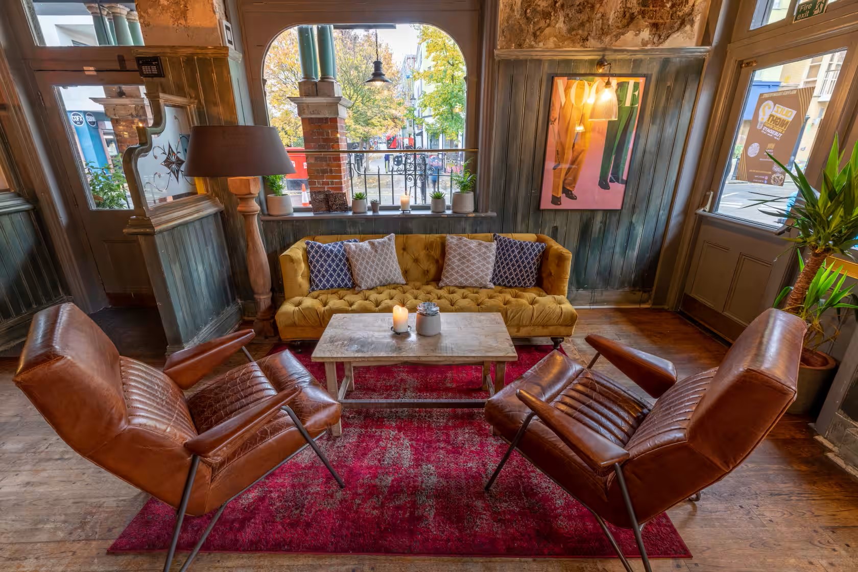 Stylish lounge area with yellow sofa for networking events at Wolfpack Fulham Inn.