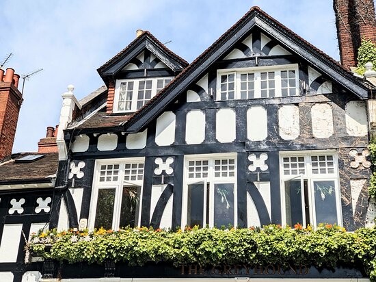 Charming historic bar with black and white facade, ideal for events and gatherings.