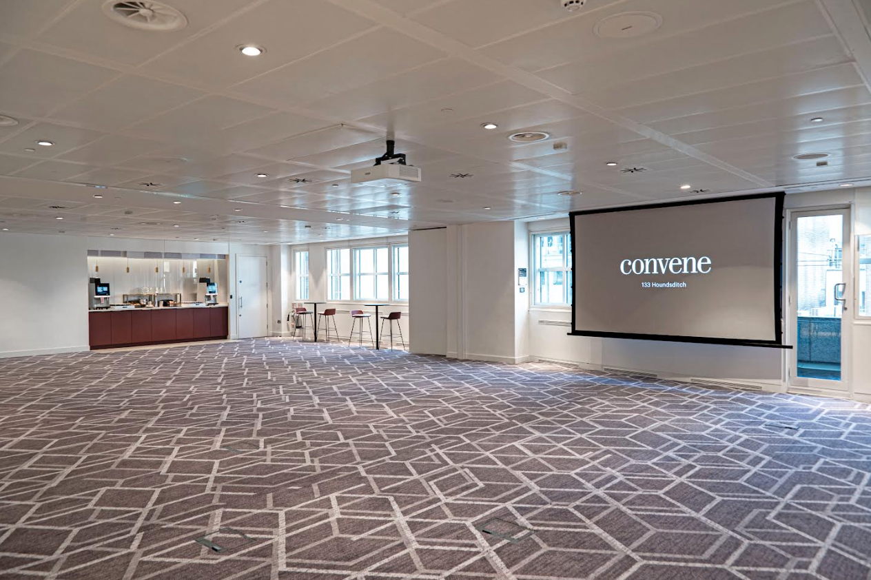 Versatile event space with natural light and projection screen at Convene 133 Houndsditch.