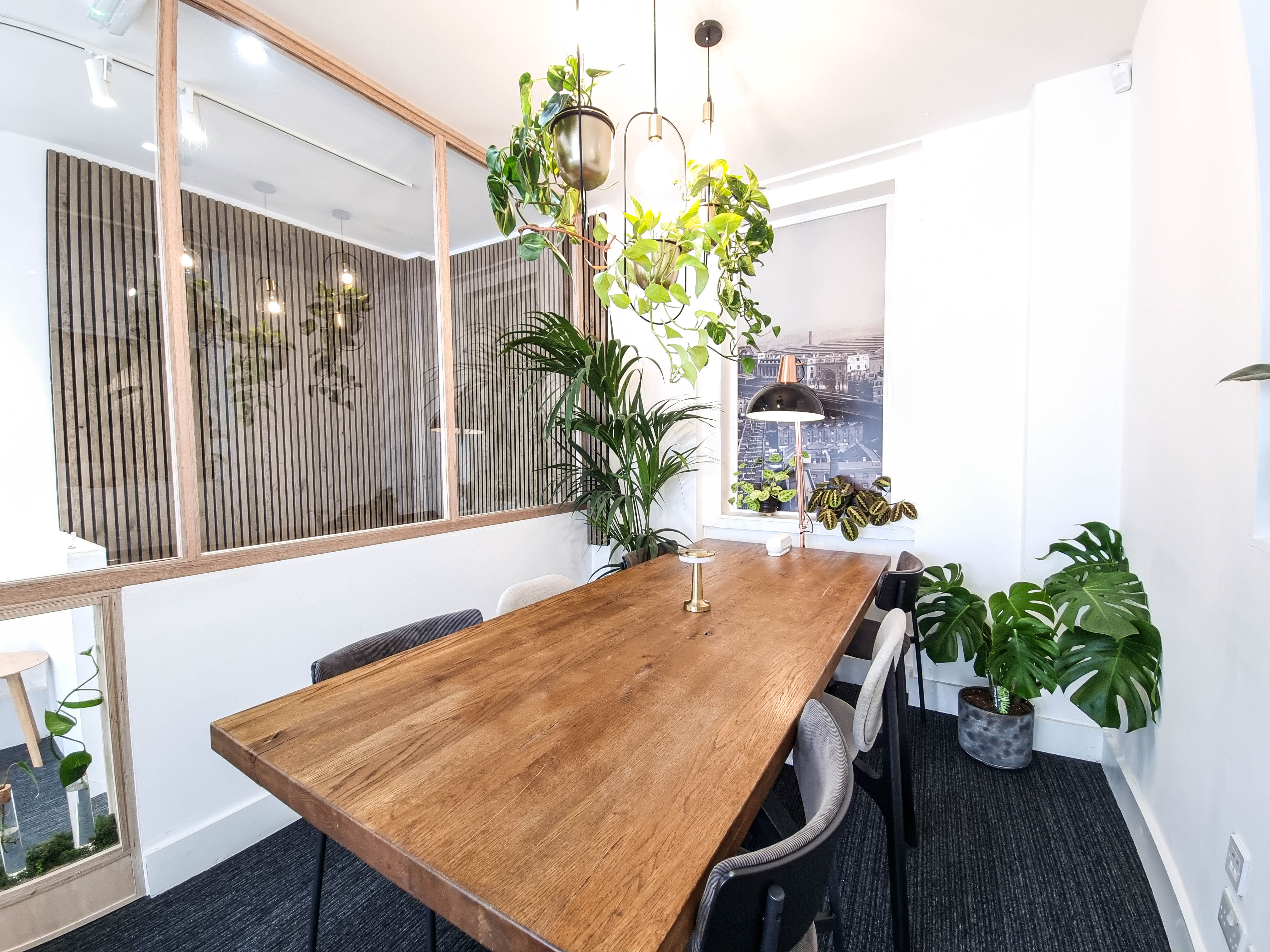Modern meeting room with wooden table, ideal for creative brainstorming sessions.