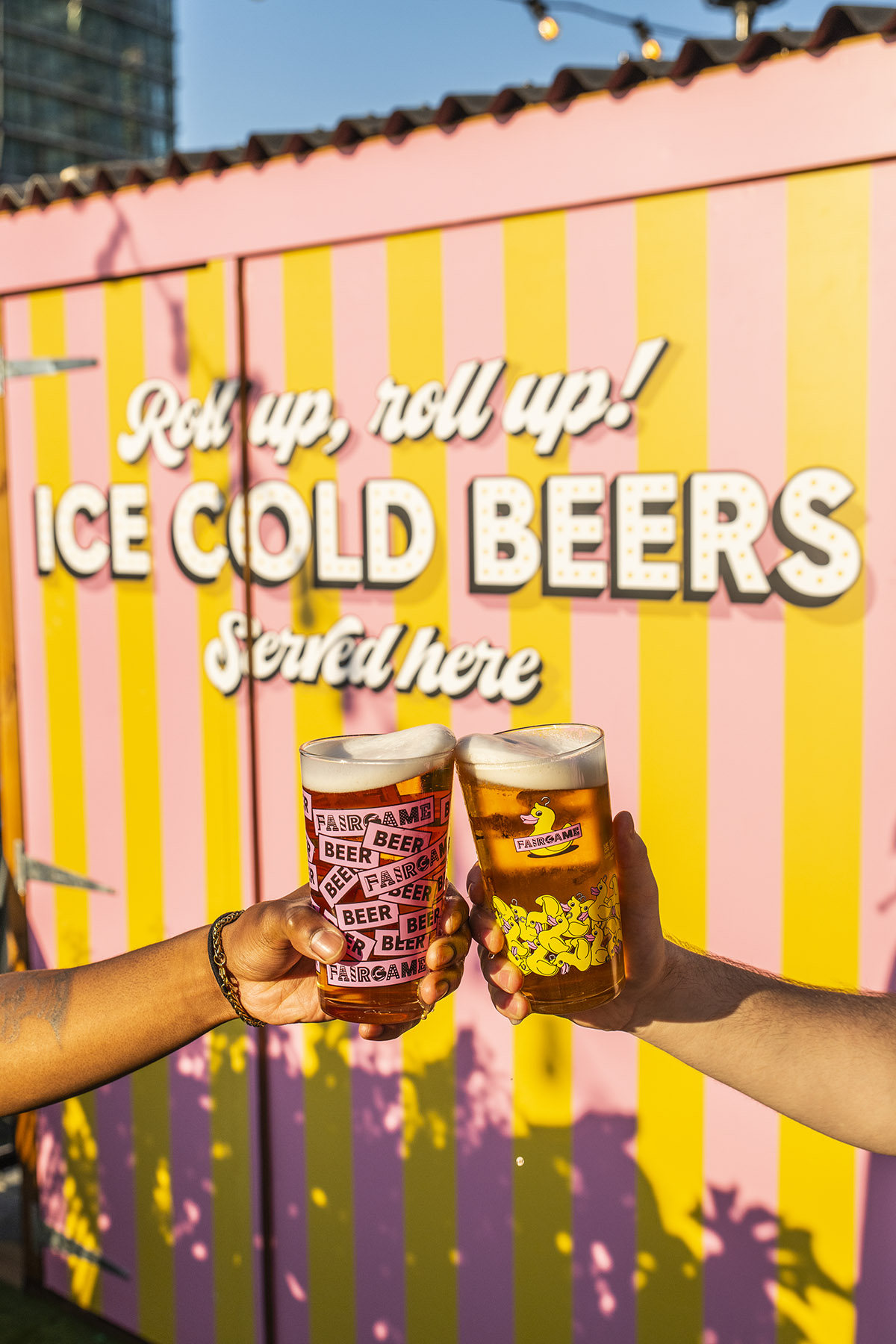 "Summer Terrace in Fairgame: vibrant outdoor social gathering with toasting beers."