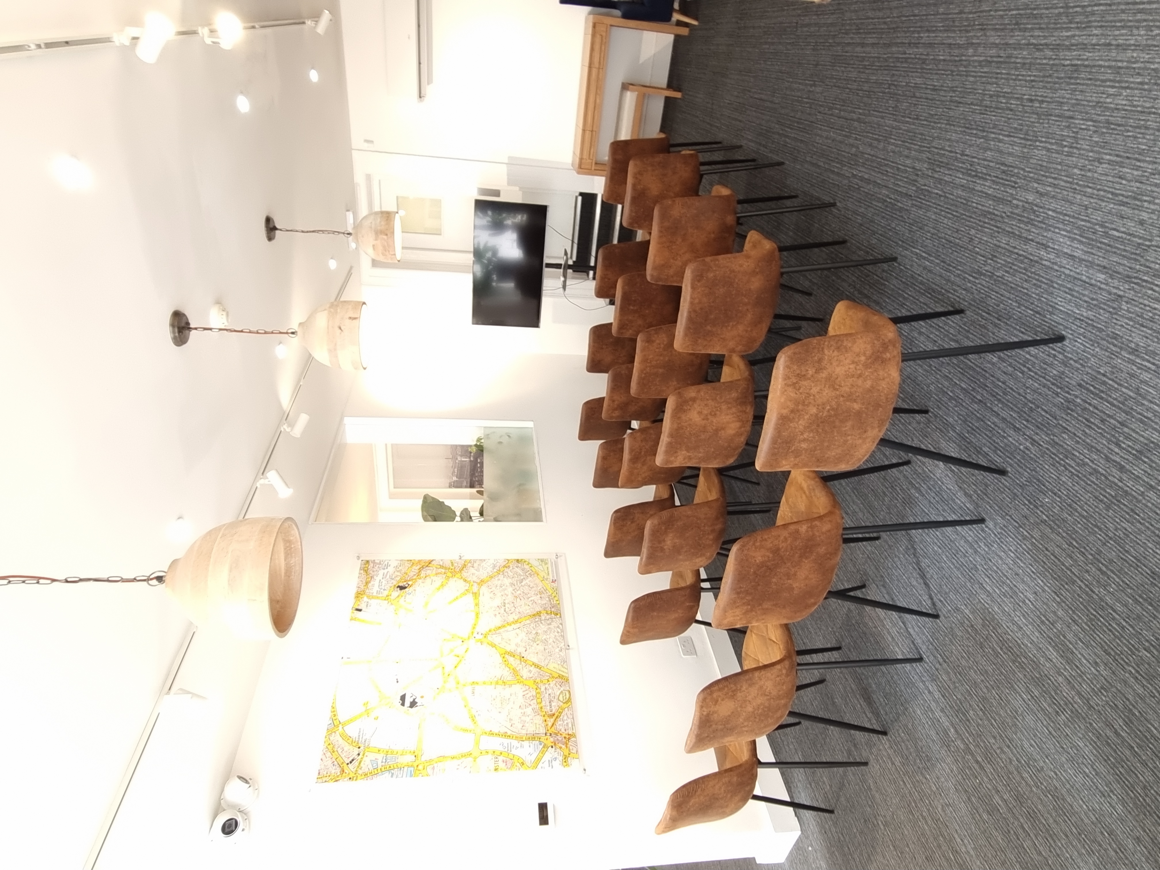 Whole Venue at The Travel Cafe Lounge, featuring brown chairs for meetings and presentations.