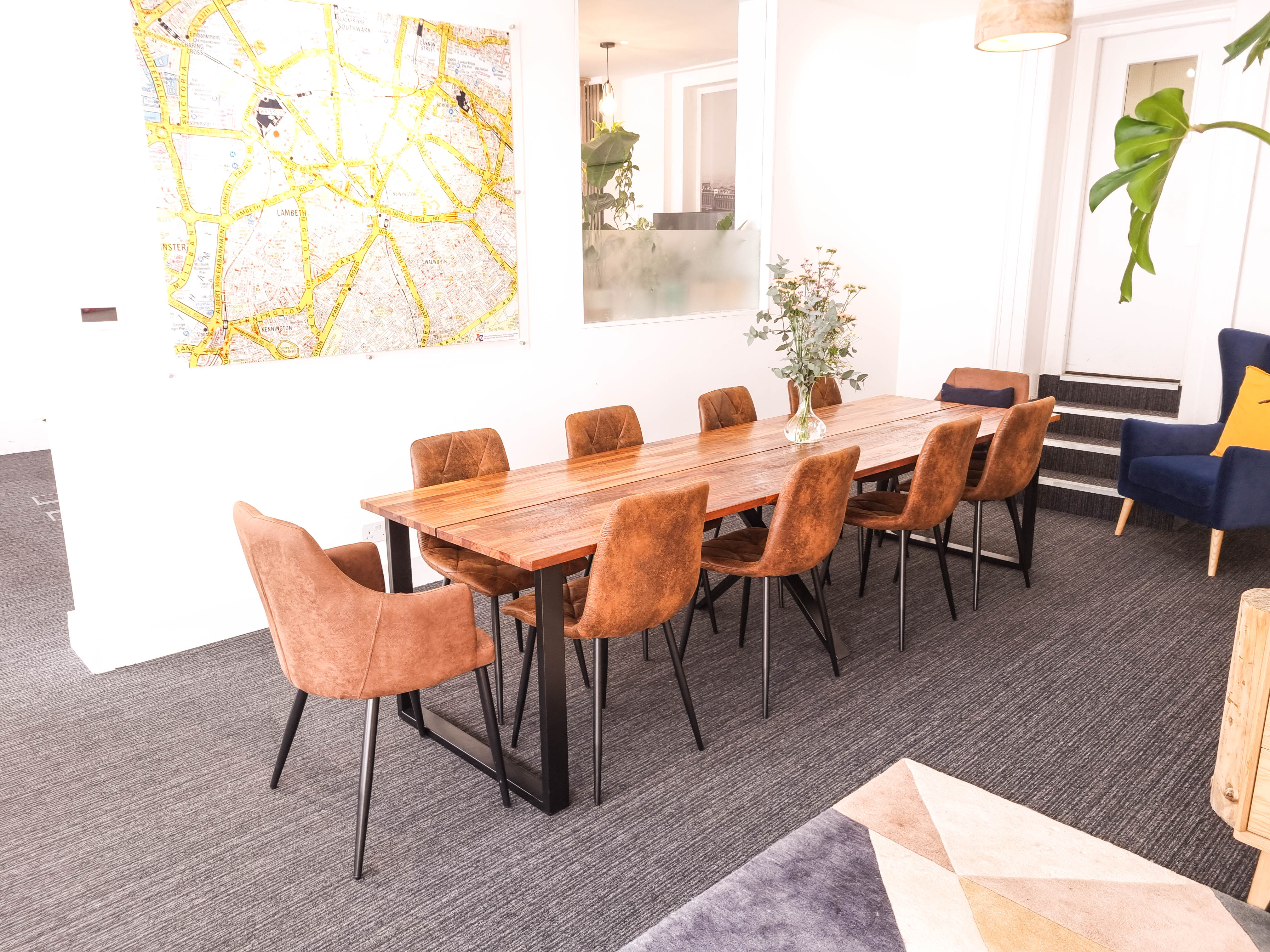 Modern meeting space with wooden table, ideal for events and gatherings at The Travel Cafe.