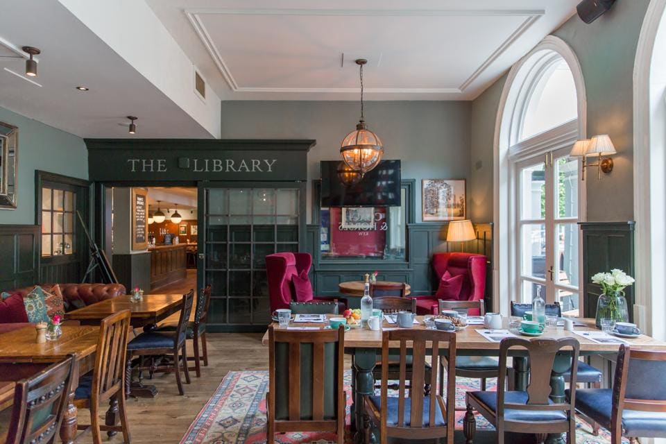 Charming dining room with rustic tables, perfect for intimate gatherings and receptions.