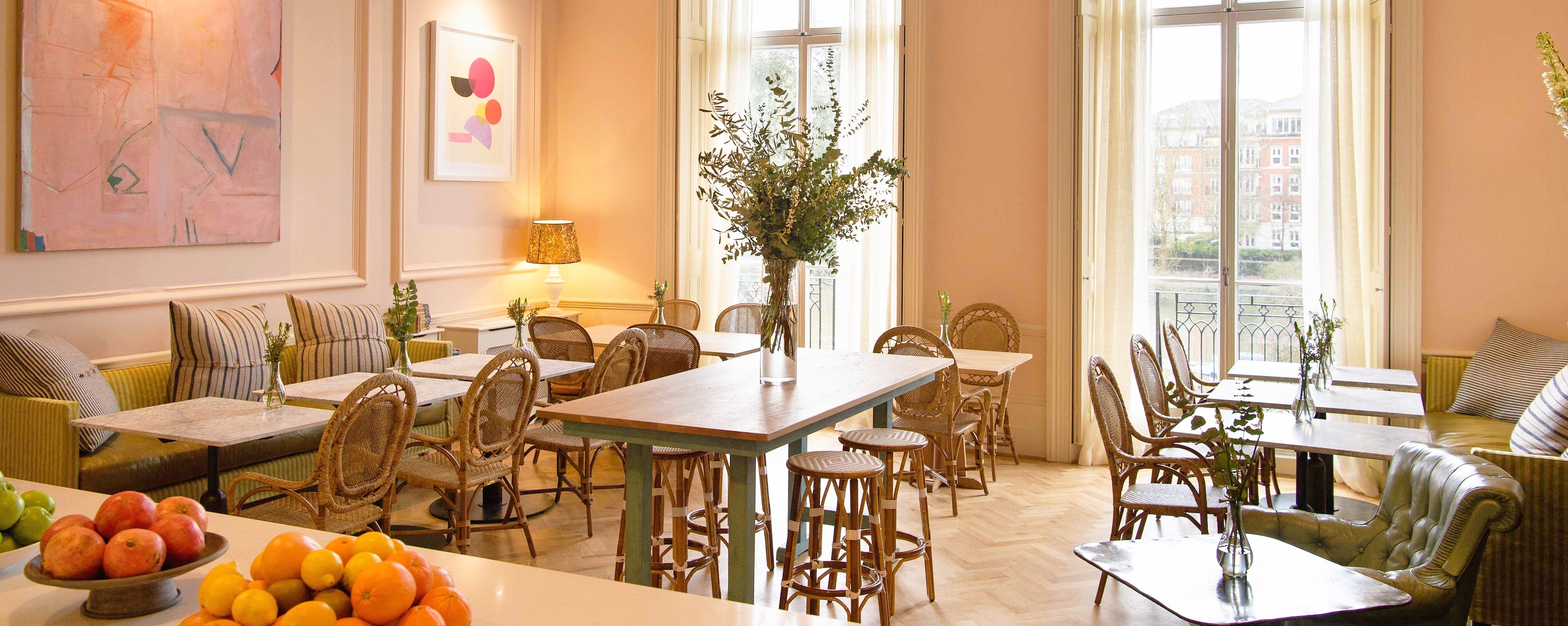 Stylish dining room with floral centerpiece, ideal for meetings and workshops.
