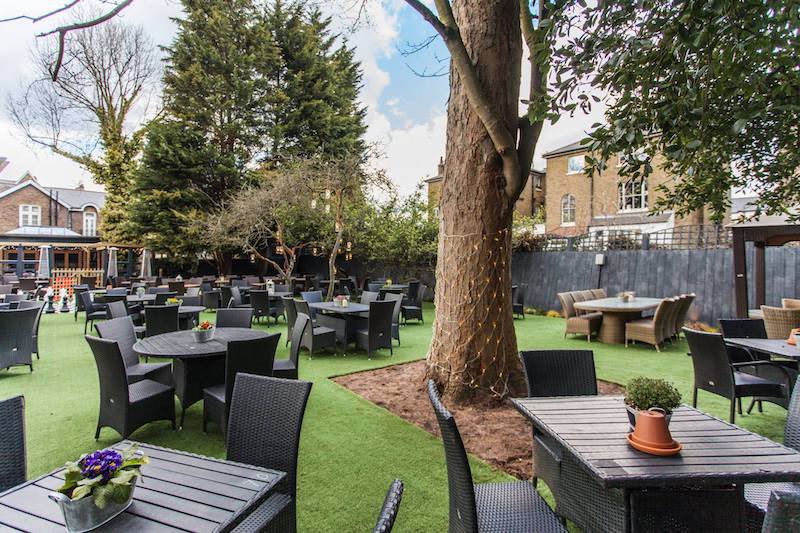 Spacious outdoor garden venue with tables for events in The Marlborough Richmond.