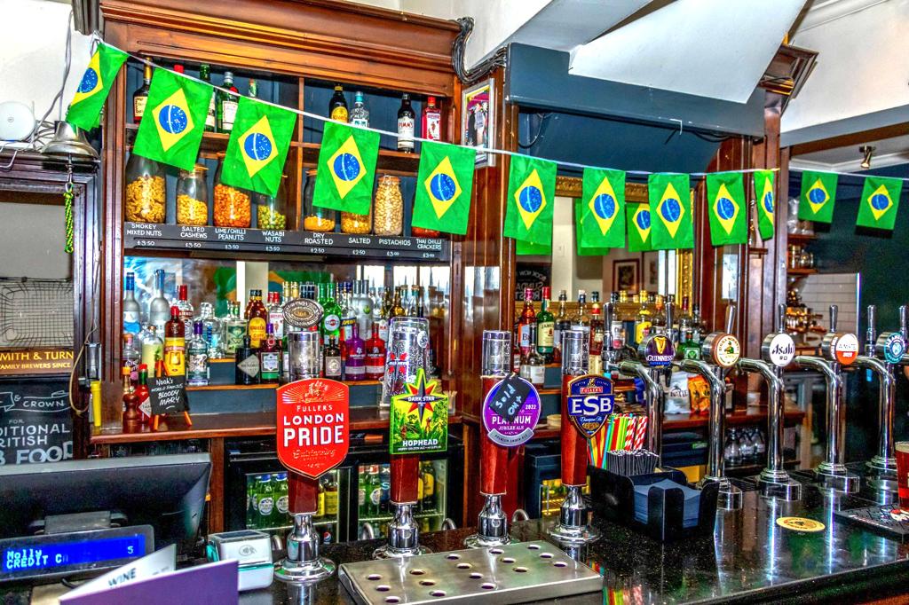 Vibrant bar setup with Brazilian flags for casual networking events at The Angel & Crown.