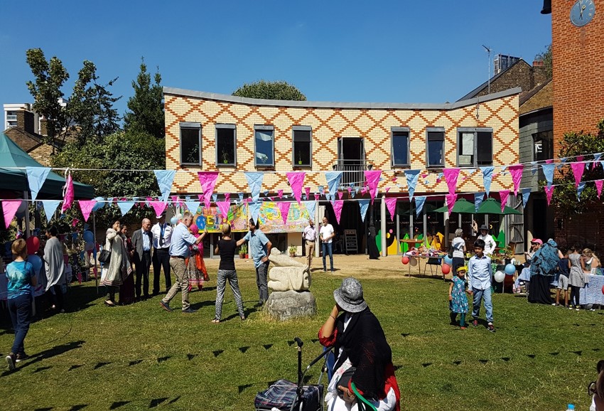 Bromley by Bow Centre outdoor event space with colorful bunting for gatherings and celebrations.