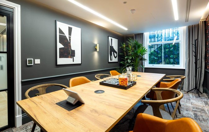 Modern Hackney meeting room with wooden table, ideal for professional events and discussions.