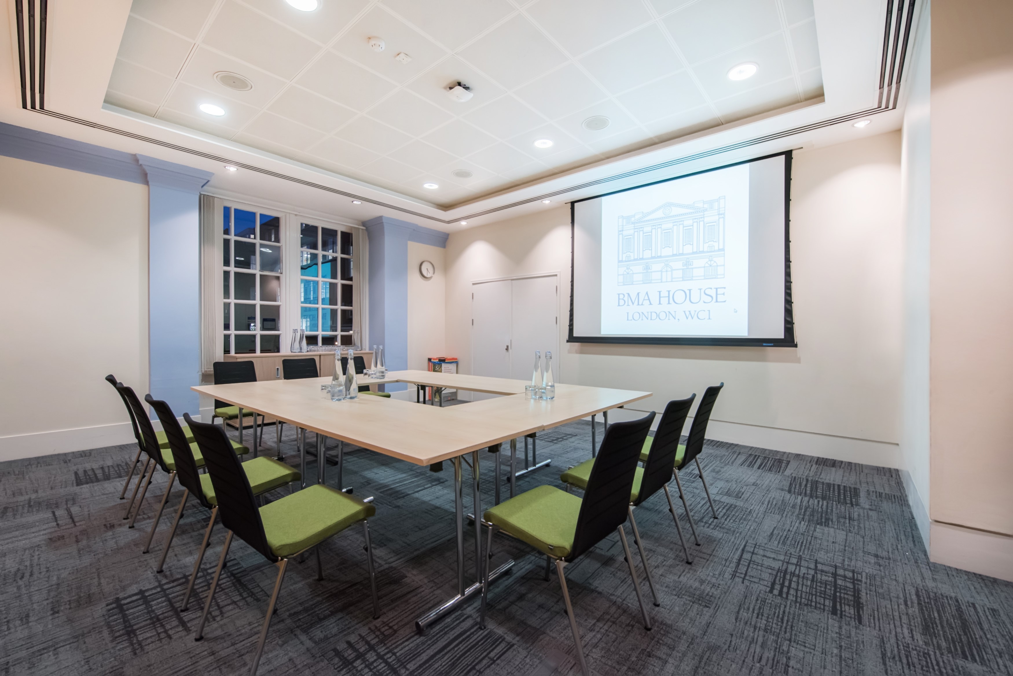Well-lit Hackney Venues meeting room with ergonomic chairs for professional events.