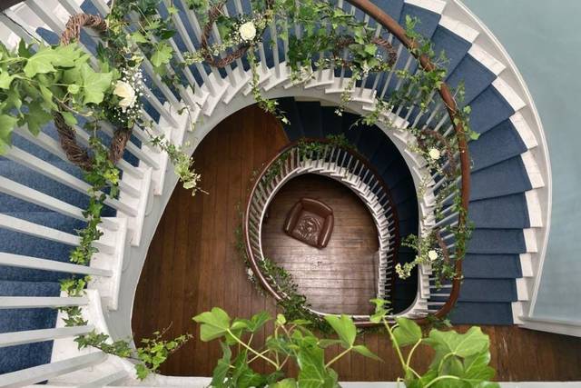 Spiral staircase with greenery in South Atrium, perfect for weddings and upscale events.