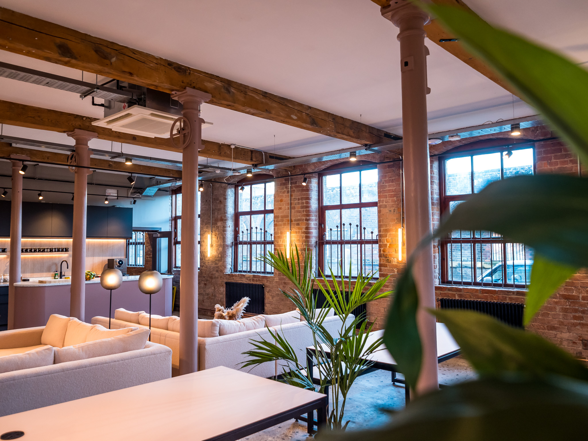Modern meeting room with exposed brick, ideal for networking events and casual meetings.