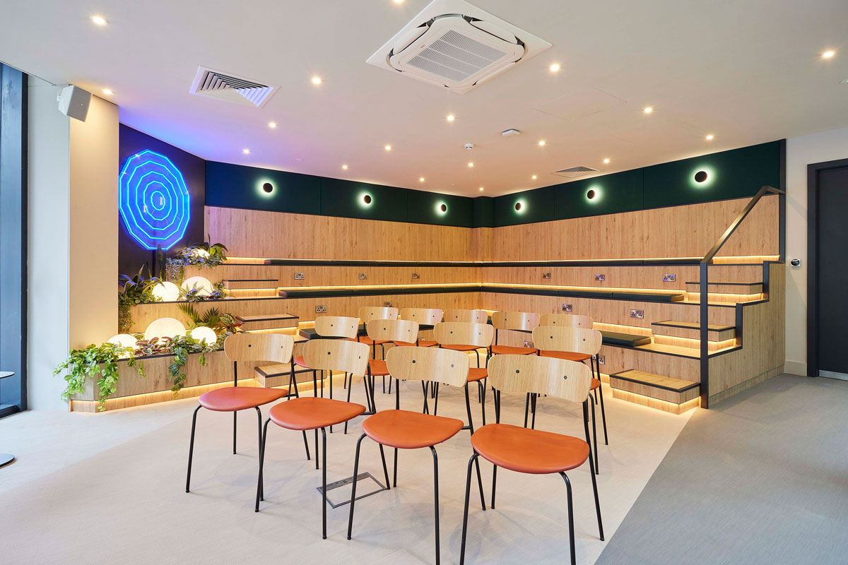 Modern event space with tiered seating for presentations and workshops at Colony Fabrica.