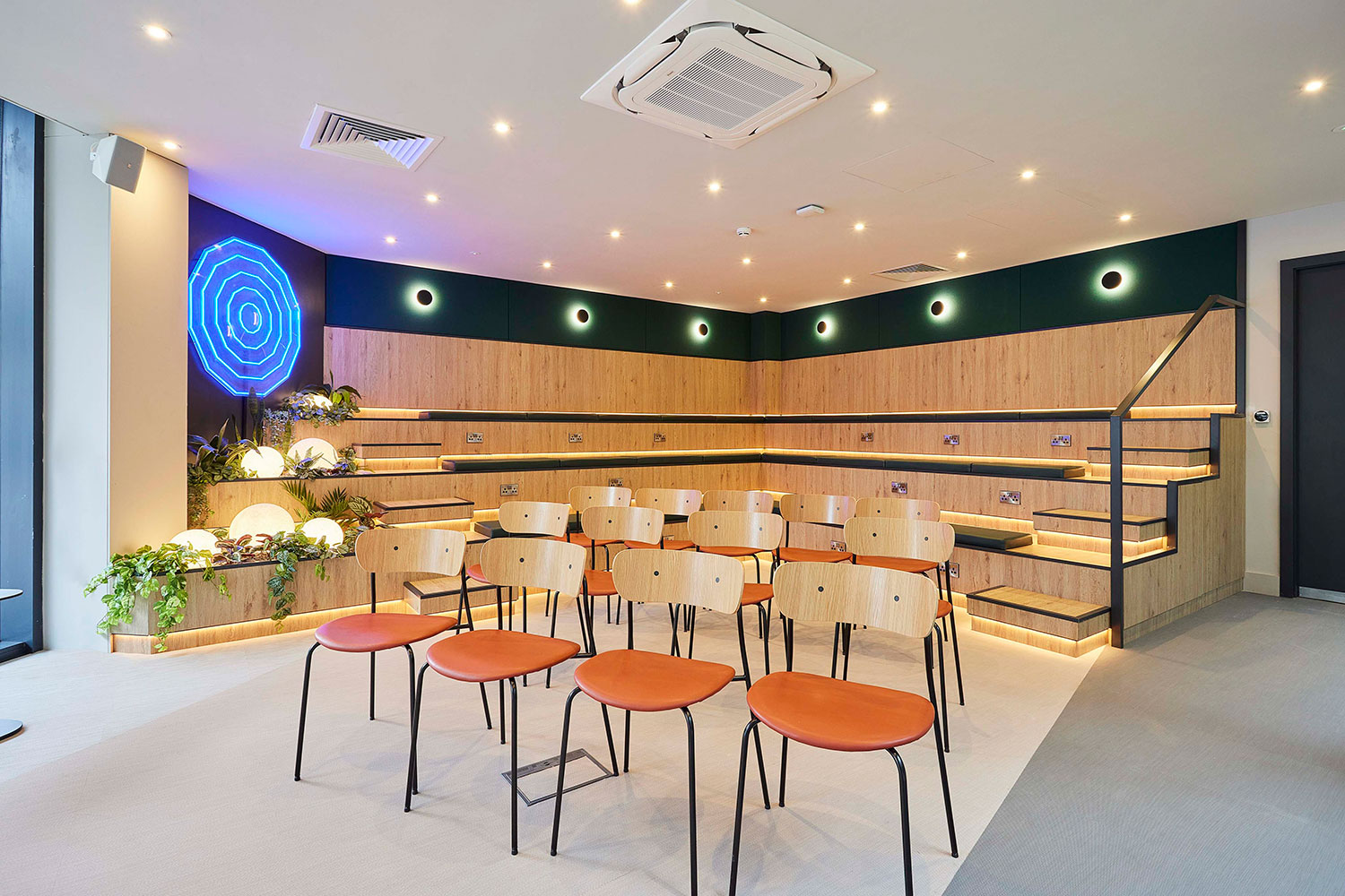 Modern event space with tiered seating for intimate gatherings and presentations.