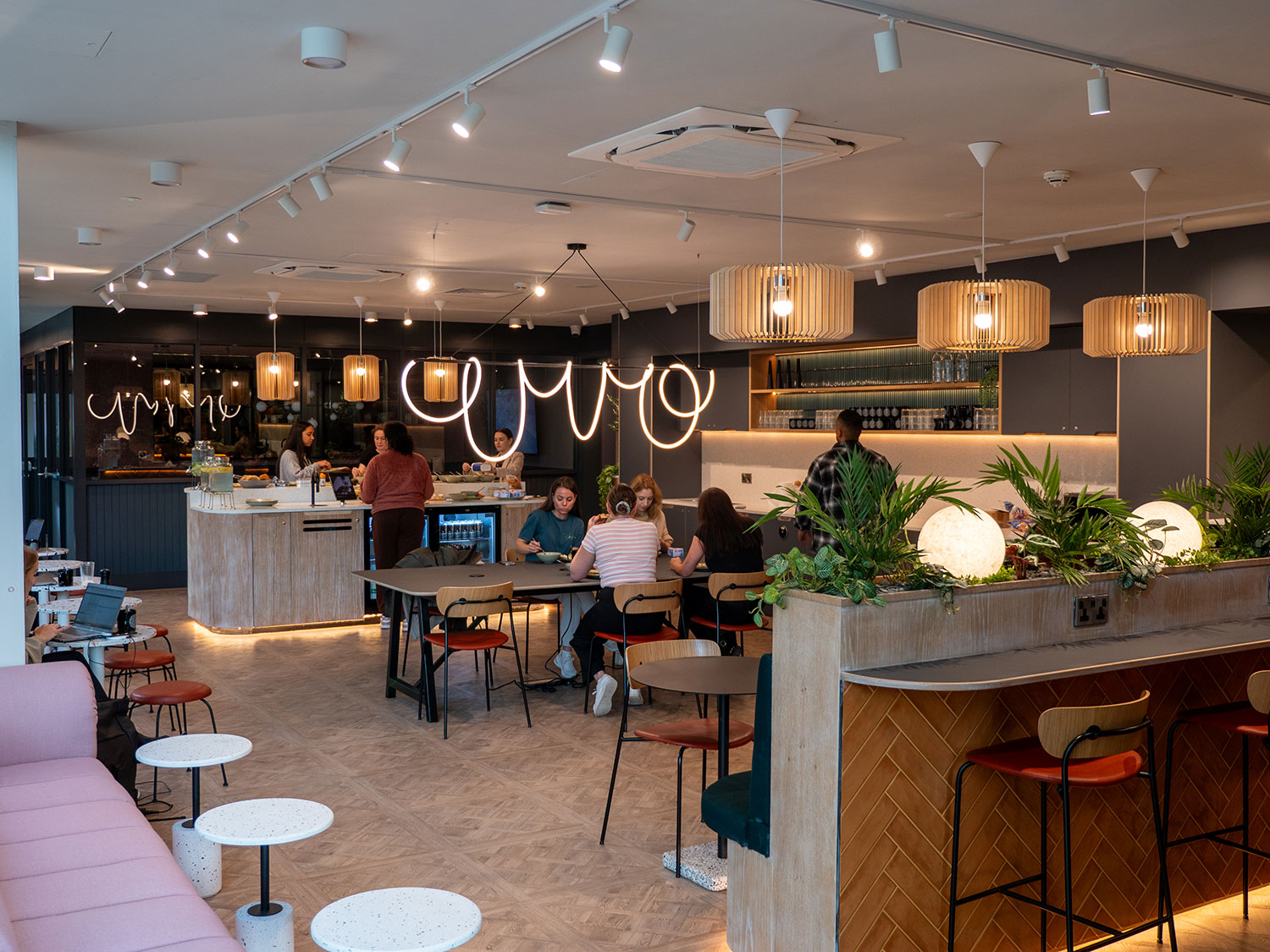 Modern café space with warm lighting, ideal for networking and informal meetings.