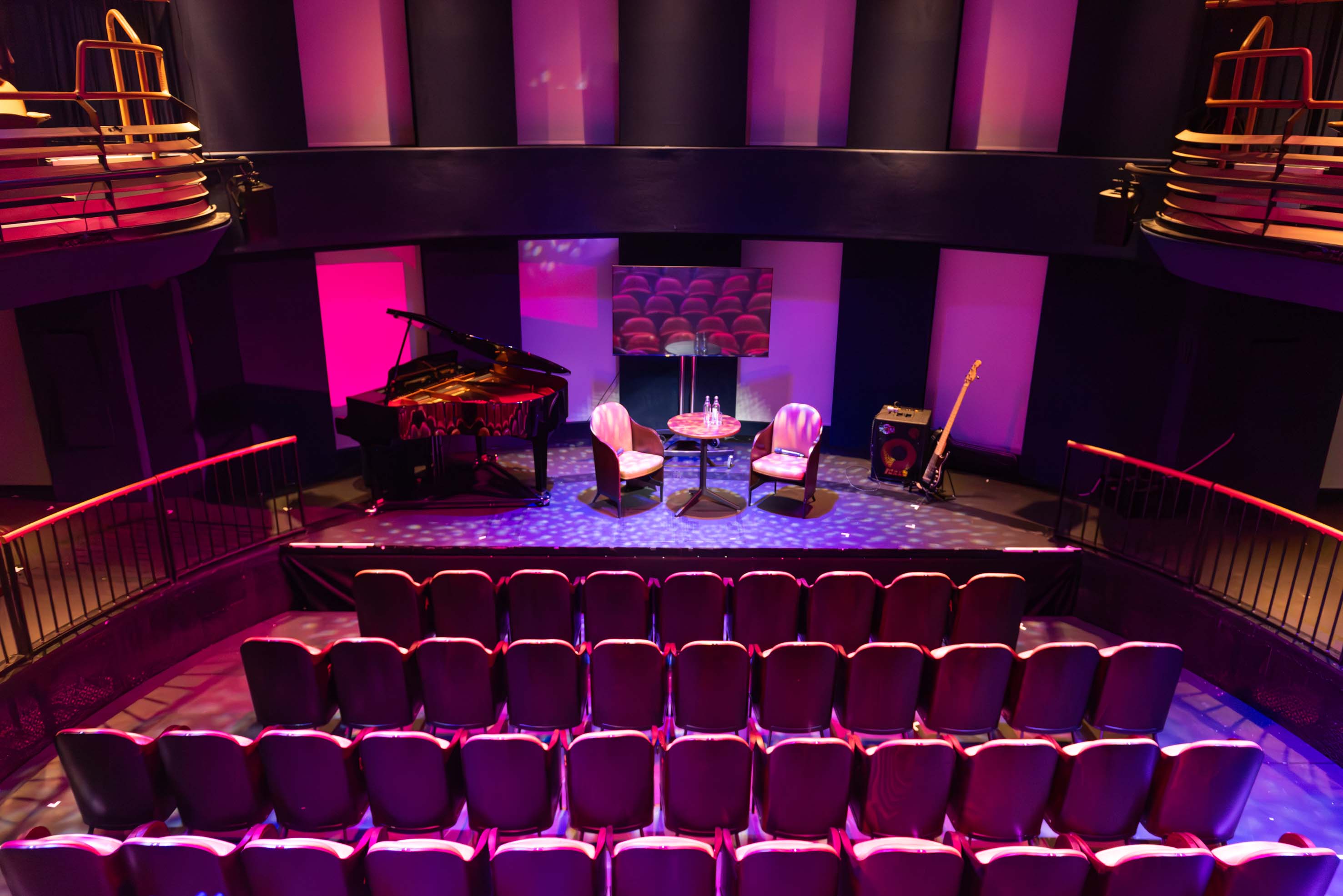 Intimate event space with grand piano, perfect for concerts and discussions.