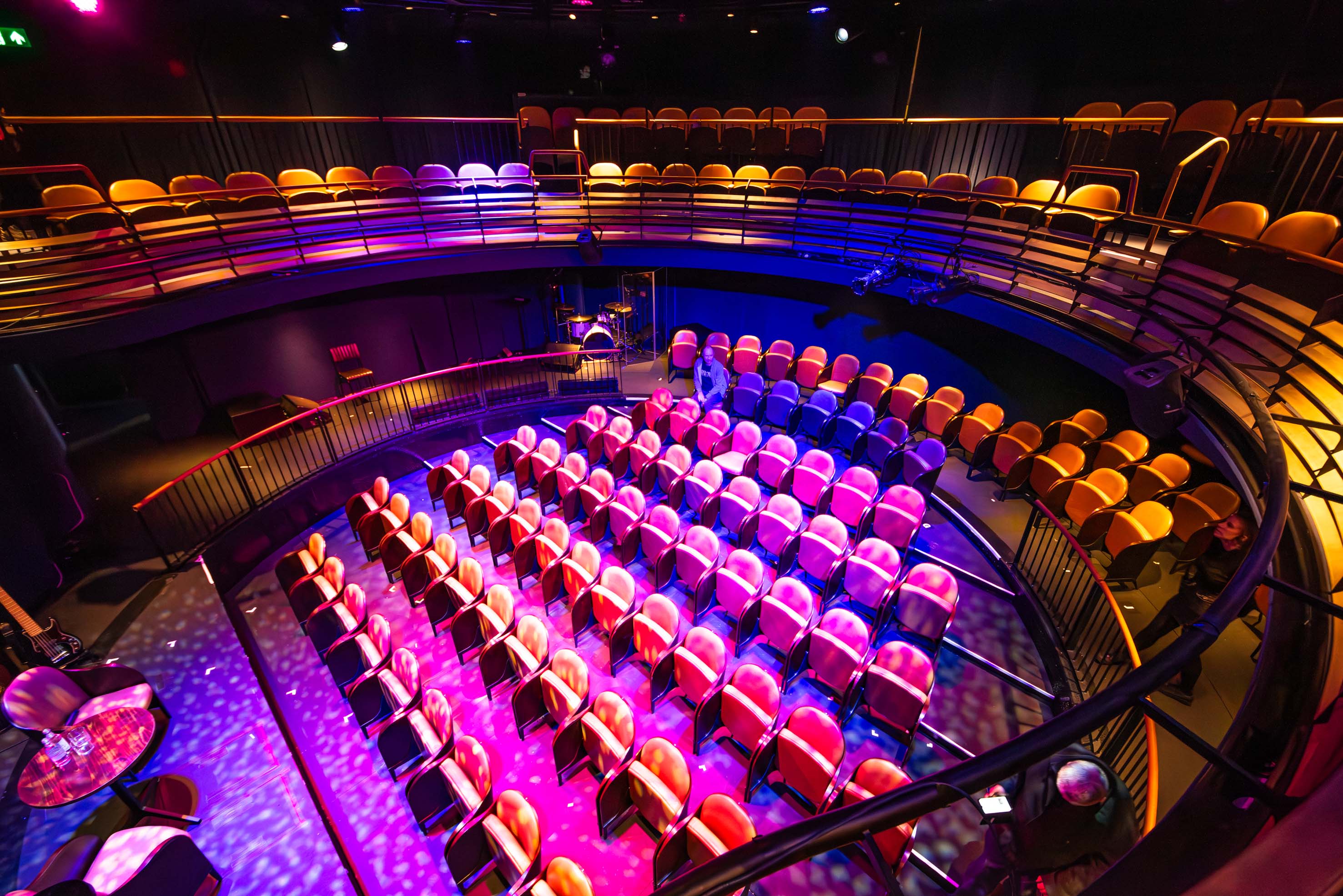 Auditorium in Underbelly Boulevard with tiered seating for live events and workshops.
