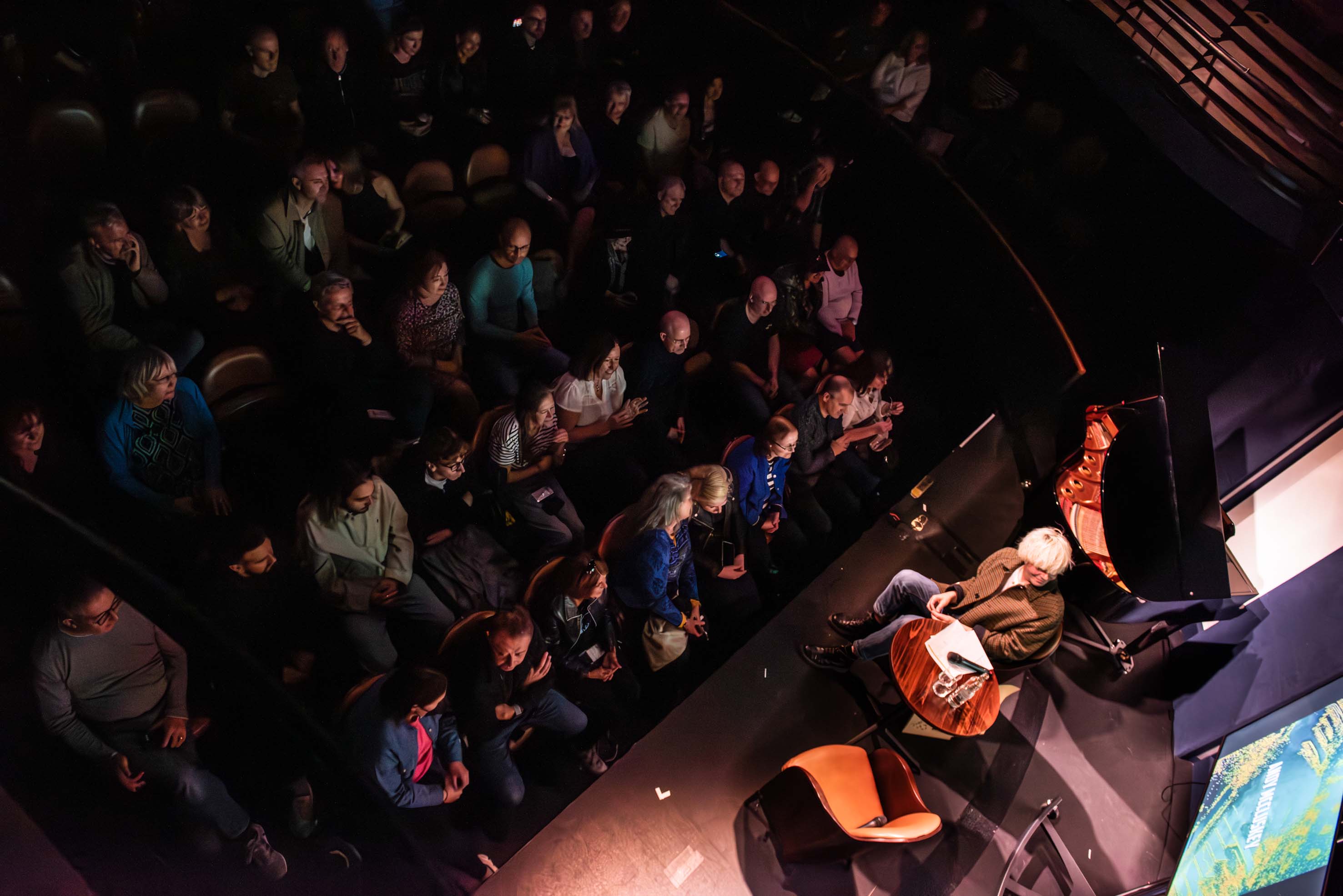 Intimate performance at Underbelly Boulevard with warm lighting and engaging seating.
