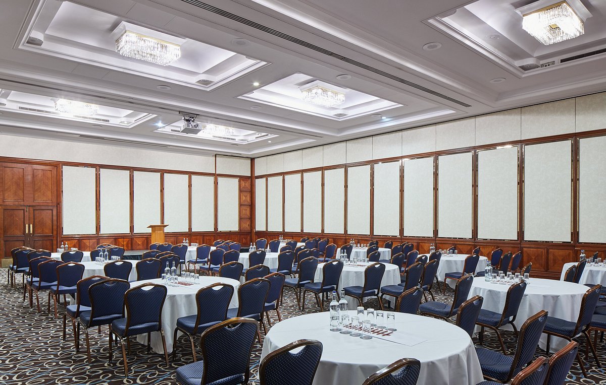 Elegant meeting room with round tables, ideal for corporate events and conferences.