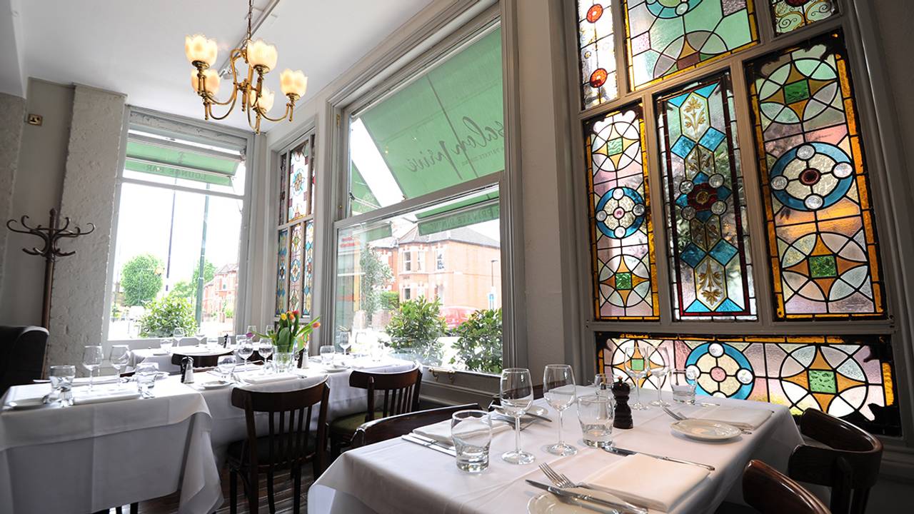 Elegant dining area with stained glass windows for upscale events and intimate gatherings.