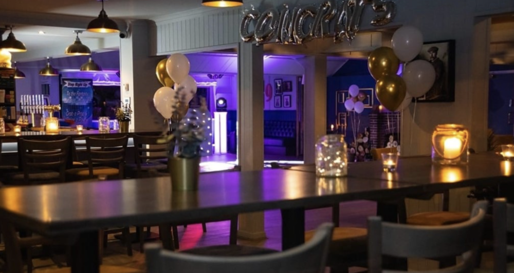 Ambassadors Club at Arkley Golf: elegant event space for celebrations with warm lighting.