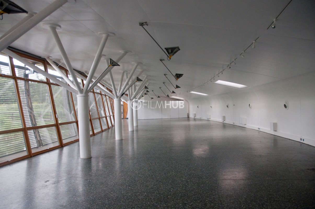 Contemporary glass-walled event venue ideal for conferences and workshops.