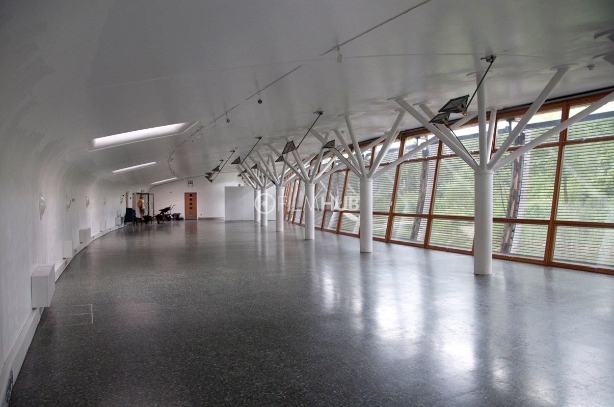 Contemporary glass-walled event venue with natural light for workshops and conferences.