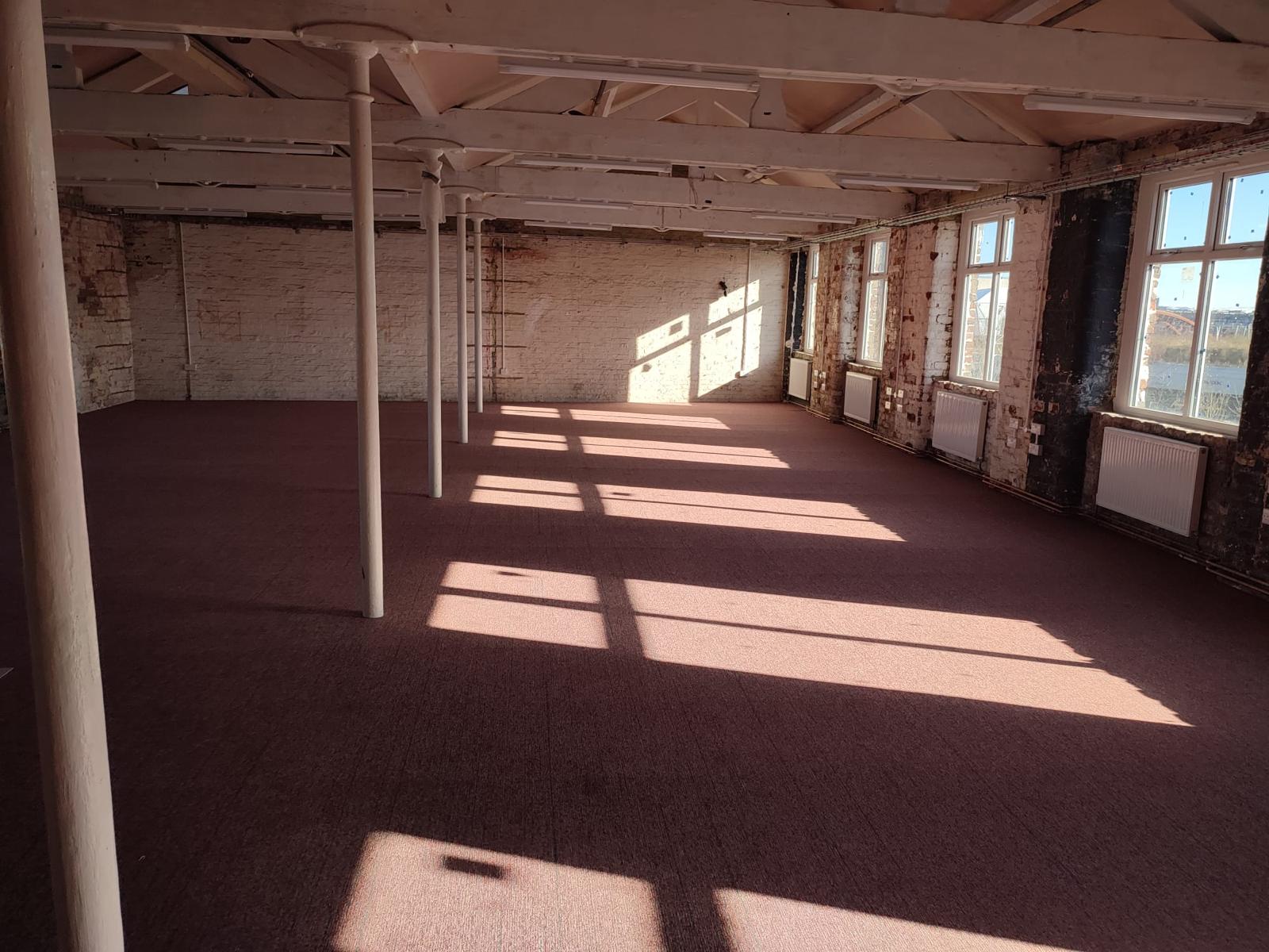 Spacious New Islington Mill venue with natural light for workshops and networking events.