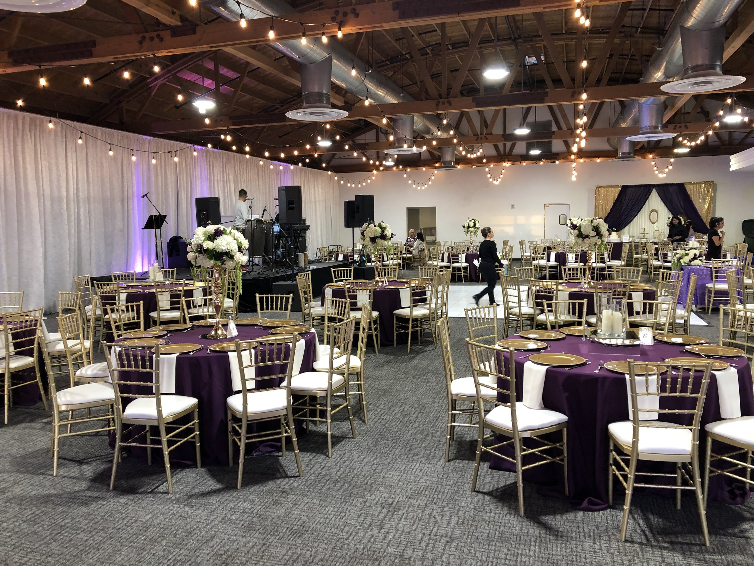 Elegant event space with gold chiavari chairs, perfect for weddings and gatherings.