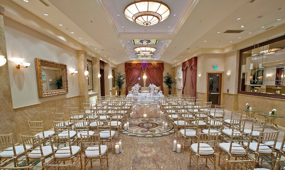 Elegant wedding ceremony setup in Taglyan Complex with gold chiavari chairs and altar.