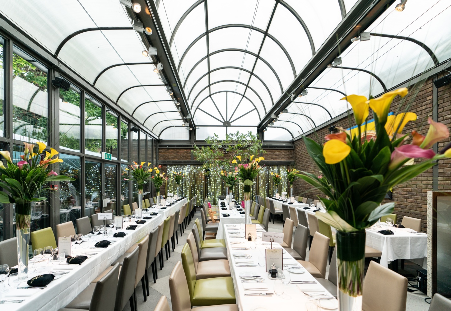 Elegant dining table in bright event space for weddings and corporate dinners.