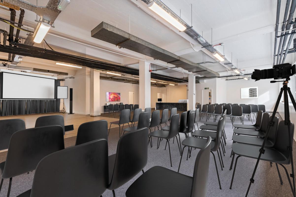 Versatile event space with black chairs for presentations at 24-26 Baltic St W.