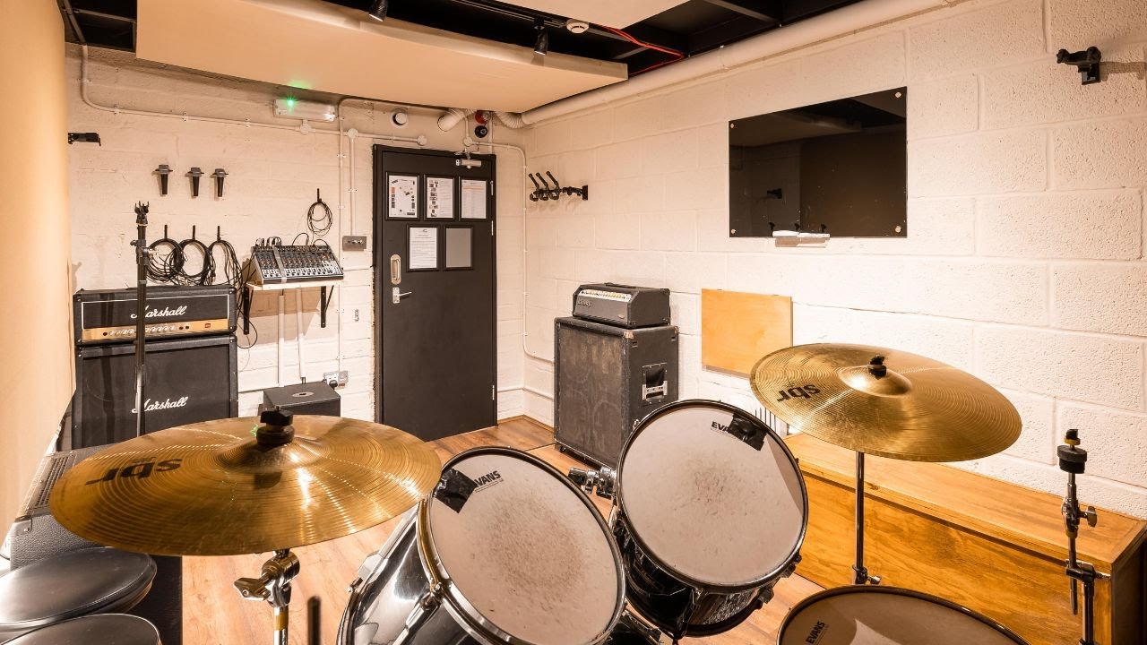 Recording studio with drum set, ideal for music events and workshops.